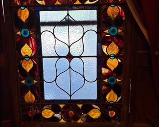 Beautiful antique leaded glass window featuring a texture central glass w elaborate leading , framed by a colorful border with yellow-gold floral motifs, red glass and small blue jeweled glass accents - Victorian era