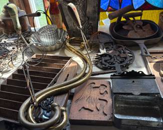 Bunny chocolate molds, kitchen utensils, trivets wood and cast iron, cast iron skillets, baking tins, wire mashers
