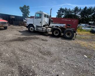 Older white semi truck freightliner side view 