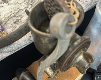 vintage hand-crank metal meat grinder
