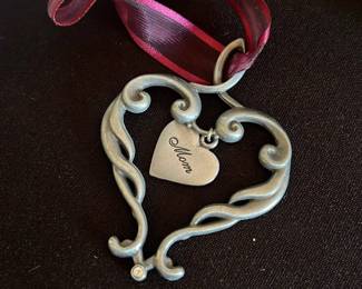 metal heart ornament that says "Mom"