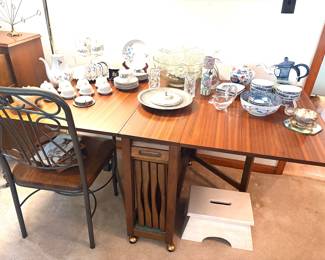 Mid century space saver drop leaf dining table with chairs stacked in middle