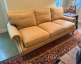 Custom designer sofa with nailhead and on castors 