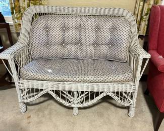 White wicker loveseat with cushions