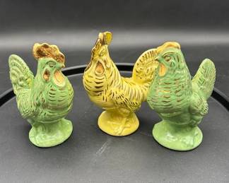 mid20th century set of three ceramic rooster and hen figurines with gold trim.