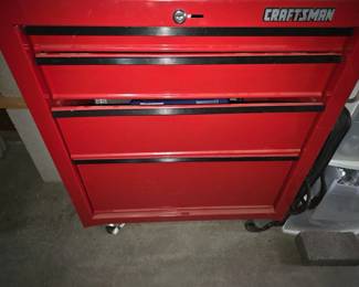 Craftsman Red Tool Chest — Sturdy red Craftsman tool chest with multiple drawers and a locking top compartment; appears to be a lower cabinet on casters shown with some light surface wear and scuffs consistent with normal garage use. Solid steel construction with black drawer trim and a visible Craftsman badge on the top front. No major dents visible in photos and drawers appear functional, though only visual inspection was performed. Measures roughly like a standard lower tool cabinet and is ready to store hand tools and hardware.