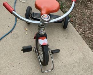 red child's tricycle