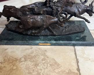 Frederic Remington-Style bronze sculpture of a cowboy on horseback during a cattle stampede