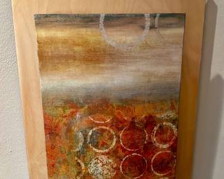 An abstract multi textured painting displayed in a curved wooden wall sconces frame