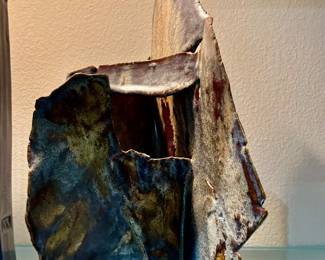an abstract expressionist, ceramic sculpture with folded slab construction and a textured multi toned glaze