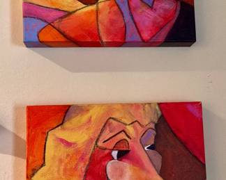 A pair of abstract Picasso style portrait paintings