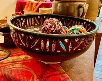 Dark ceramic decorative bowl featuring intricate perforated pattern along the rim