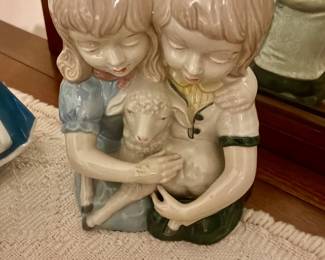 Porcelain statue with children holding lamb