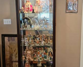 Swarovski and Hummel Collection (and more) inside of a Side-entry Curio Cabinet
