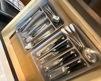 Kitchen Flatware
Price: $35.00
Condition: Good
Assorted stainless-steel flatware and cutlery grouped in a kitchen drawer organizer, including multiple spoons, forks, and several black-handled knives.