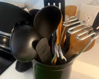 Cooking Utinsels
Price: $20.00
Condition: Good
A countertop utensil crock in dark green/black holding several cooking tools, including black nylon utensils, a metal whisk, and wood-handled spoons/spatulas. Contents appear mixed and partially overlapping, so exact item count and completeness cannot be verified from the image alone.