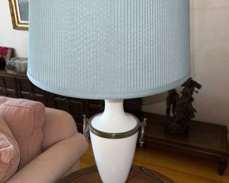 Table lamp with elegant cream base accented with decorative brass side rings