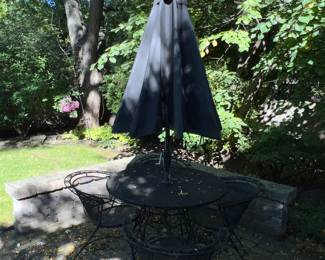 Classic wrought iron table and chairs with umbrella