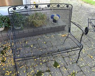 Classic black wrought iron two-seater outdoor bench