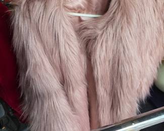         This image shows a blush pink faux fur vest from Donna Salyers' Fabulous-Furs in size 2X with a silky inner lining.            