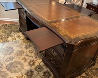 desk featuring triple pull out writing board