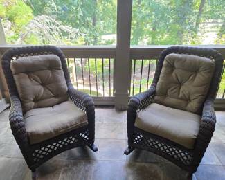 Pair wicker rocking chairs with tan cushions