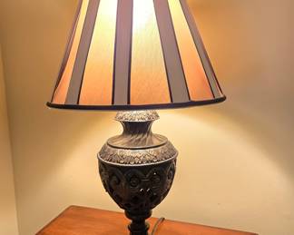 Ornate bronze urn table lamp, striped fabric shade