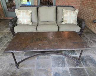 Wicker patio sofa with hammered copper-top coffee table