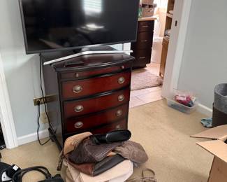 Another large TV and small chest