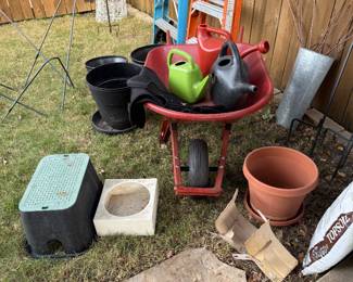 Wheelbarrow, watering cans, pots