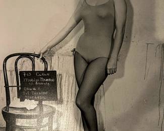 Black and white Marilyn Monroe costume test photograph with a production slate visible beside the figure