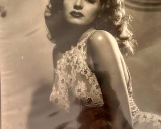 Black and white Hollywood glamour portrait of a brunette performer in a beaded gown from the Tom Culver collection