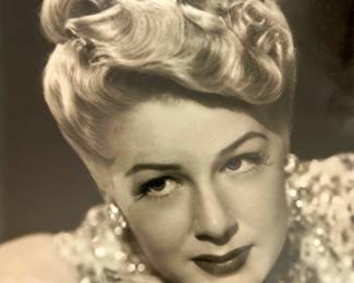 Black and white Hollywood portrait of a blonde performer in a patterned blouse from the Tom Culver photograph collection