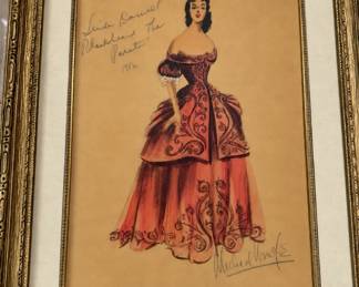 Framed costume illustration of a richly patterned red period gown with handwritten Blackbeard the Pirate inscription