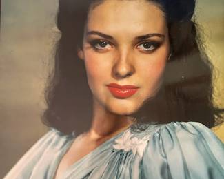 Color Hollywood portrait of a dark haired performer in a pale blue dress from the Tom Culver photograph collection
