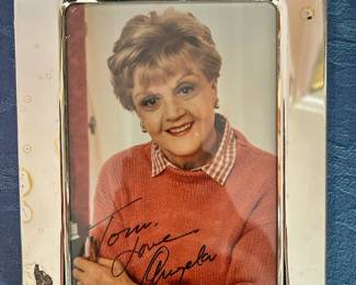 Angela Lansbury commemorative photograph in a metallic frame with a handwritten inscription and Murder She Wrote anniversary dates