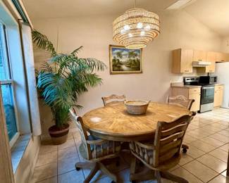 Charming dinette table with insert. Chairs on wheels where you eat meals!