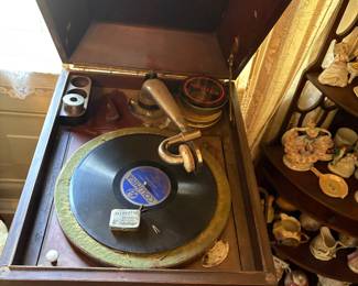 Working Victorian record player on stand with two doors that open to reveal record storage on the front 