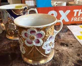 Beautiful hand painted coffee cups with applied flowers and gold leaf paint 