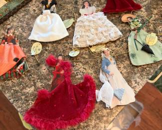 Misc  dolls and clothing priced separately on kitchen table 
