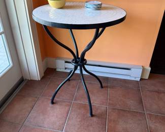 White tiled top with iron base patio table.