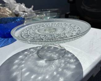 Pressed glass pedestal cake stand. Pattern is Windsor