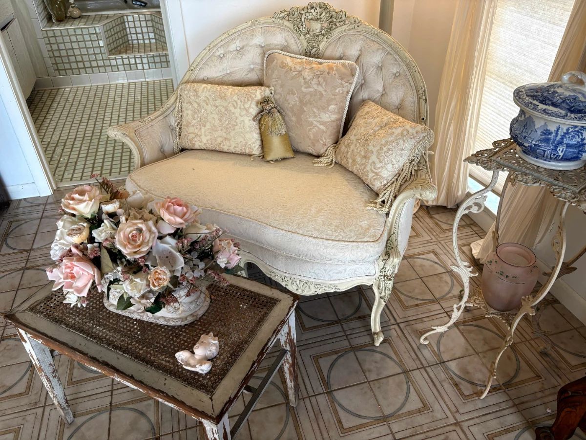 Hello, French Country! More than a chair, less than a love seat -- this white confection should go home with you! Paired nicely with that vintage little cane bench, of course!