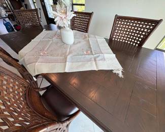 This dining room table has one leaf installed and another set to deploy. Comes with 8 chairs (2 not picutred).