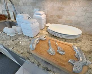 Lot of kitchen goodies -- countertop containers, cutting boards, cheese knives, platters, etc.