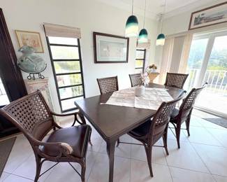 This dining room table has one leaf installed and another set to deploy. Comes with 8 chairs (2 not picutred).