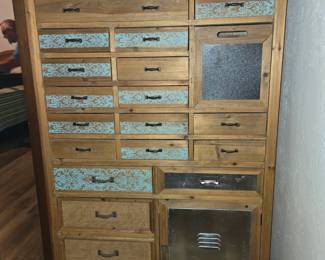 Apothecary Cabinet with Nautical Flair. Metal Accent on Bottom Right