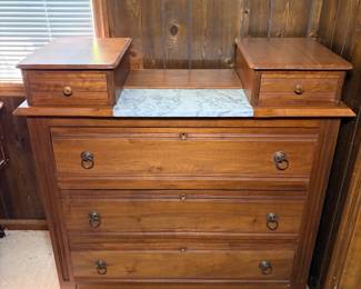 Victorian Marble Top Dresser with Glove Boxes - An antique Victorian dresser with a white marble insert on the top deck, flanked by two lift-top glove boxes with turned wooden knobs. The three full-width drawers feature reeded molding, escutcheon keyholes, and ornate ring pulls. The finish is warm and even overall with light surface wear, and the marble shows natural veining with no visible cracks in the photo. A handsome antique marble top dresser for a period bedroom, and it pairs naturally with the carved bed and chifforobe in this sale.