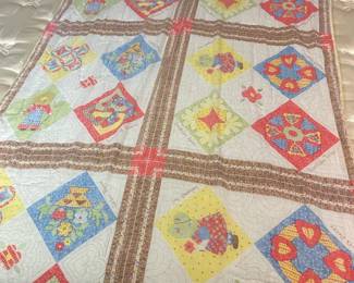 Vintage Patchwork Quilt with Brown Sashing A cheerful hand-pieced patchwork quilt with colorful appliquéd blocks set on point — baskets, hearts, fans, and floral motifs in red, yellow, blue, and green — separated by brown printed sashing with red cross-stitch accents. The hand quilting is dense and the blocks are bright with good color retention. Some age toning is visible in the white ground. A charming handmade quilt with strong visual appeal for collectors and decorators.