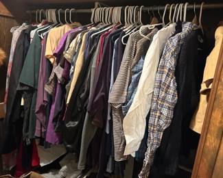 Closet Lot of Vintage Clothing A full closet rod of women's clothing including blouses, knit tops, dresses, jackets, and a plaid flannel shirt, in a broad range of colors and fabrics. Several pieces have the styling and construction of earlier decades. Individual sizes, brands, and condition were not inventoried in this photo. A volume lot for vintage clothing resellers willing to sort.